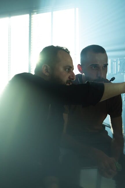 Film crew collaborating on set with cinematic lighting in Baghdad, Iraq, showcasing teamwork and creativity.