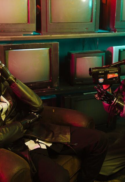 A sci-fi-inspired scene with neon lighting, featuring a man and woman using vintage technology in an atmospheric setting.