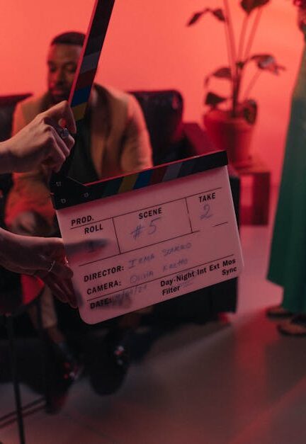 Behind the scenes of a movie set in a stylish indoor setting with clapperboard ready for action.