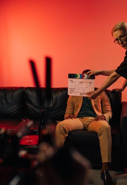 Film production team setting up a scene on an indoor set with dramatic lighting.